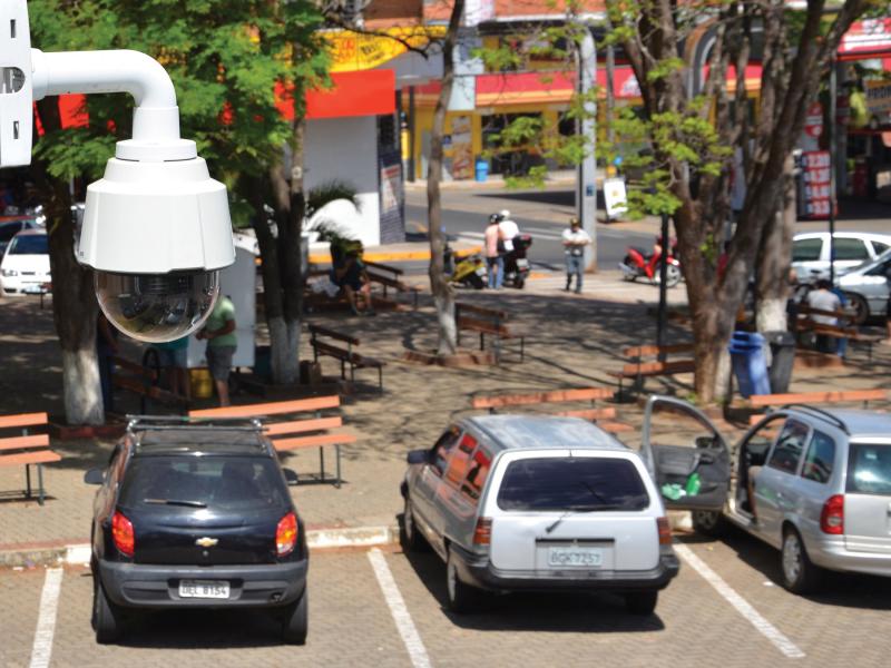 Axis camera on pole viewed from its right angle on parking lot.