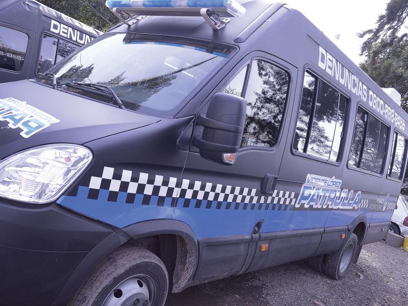 Blue police van viewed from its left angle.