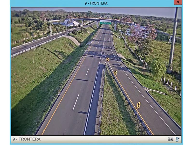 Screenshot of highway from above, grass and trees around.