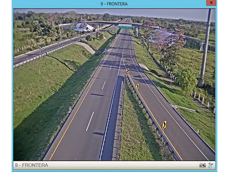Screenshot of highway from above, grass and trees around.