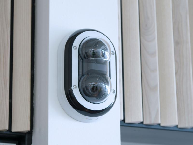 AXIS P3715-PLVE Network Camera mounted on wall outdoors from right