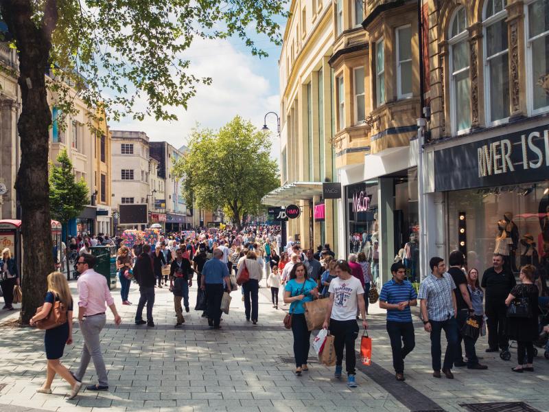 Busy city street with shops and people walking