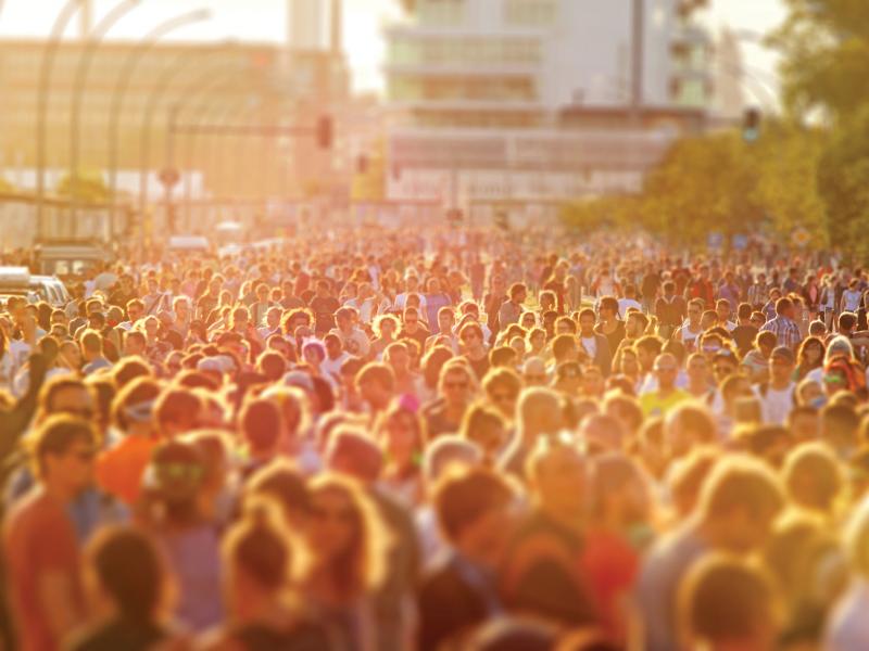 Crowd of people on a street festival in the sunset