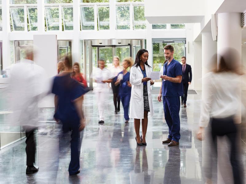 Busy hospital hallway with doctors and nurses