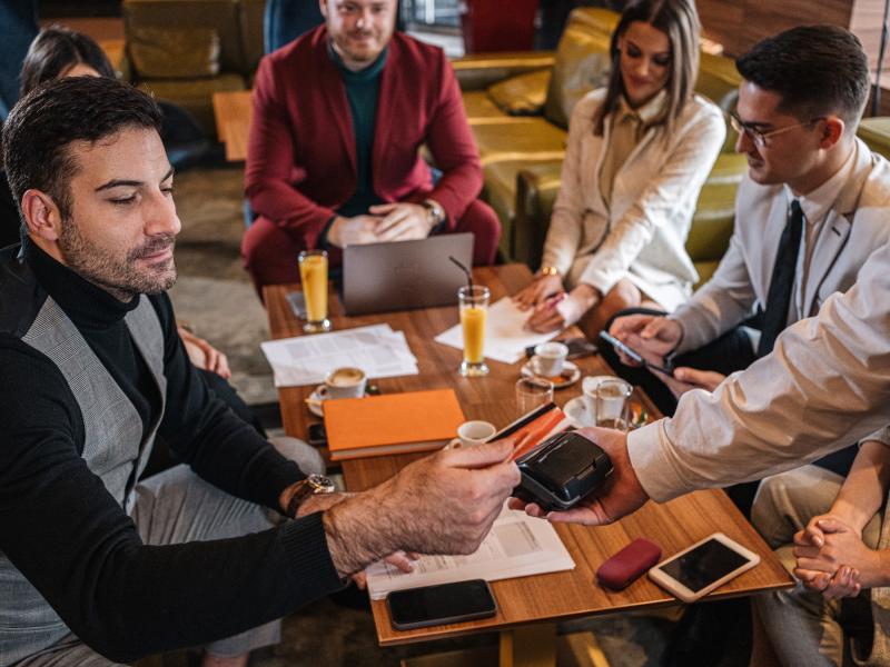 Man paying with his card in a cafe