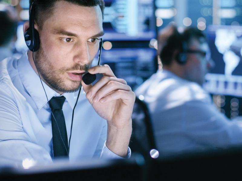 Man in a security center talks in his headset