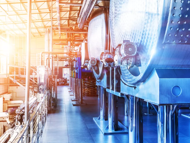 Interior environment in a large production hall with steel tanks 