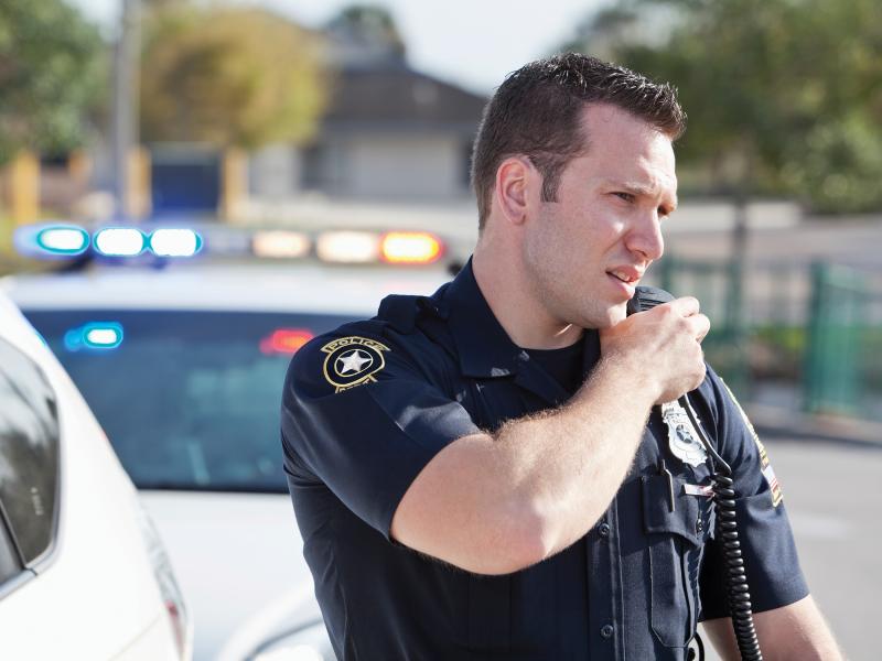 Police talking in his radio on his chest