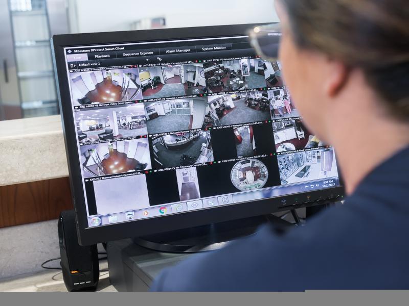 Looking over the shoulder of a nurse, watching a monitor