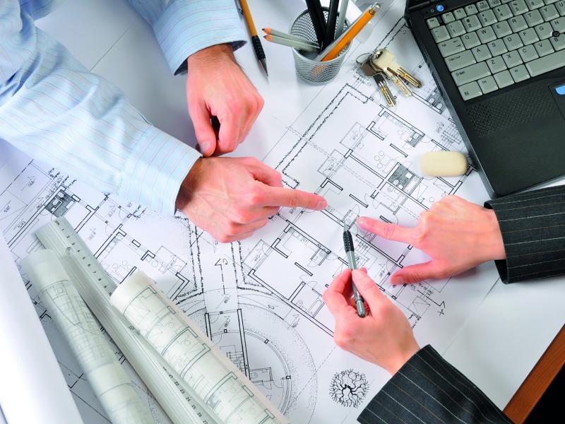 man and woman pointing on a floor plan