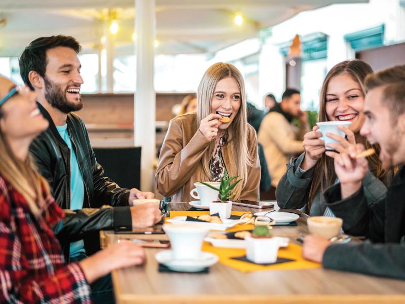 Group of friends having a coffee at a cafeteria.