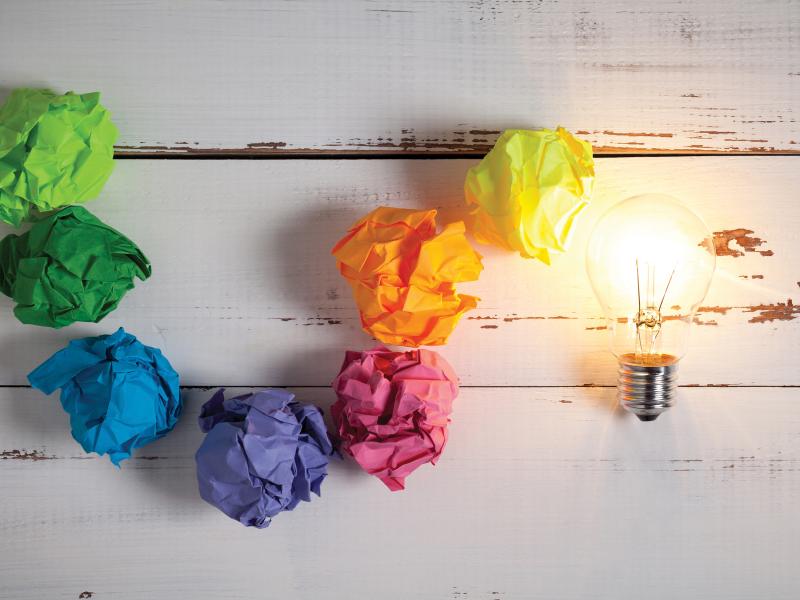 Lightbulb of crumpled paper in rainbow colors.