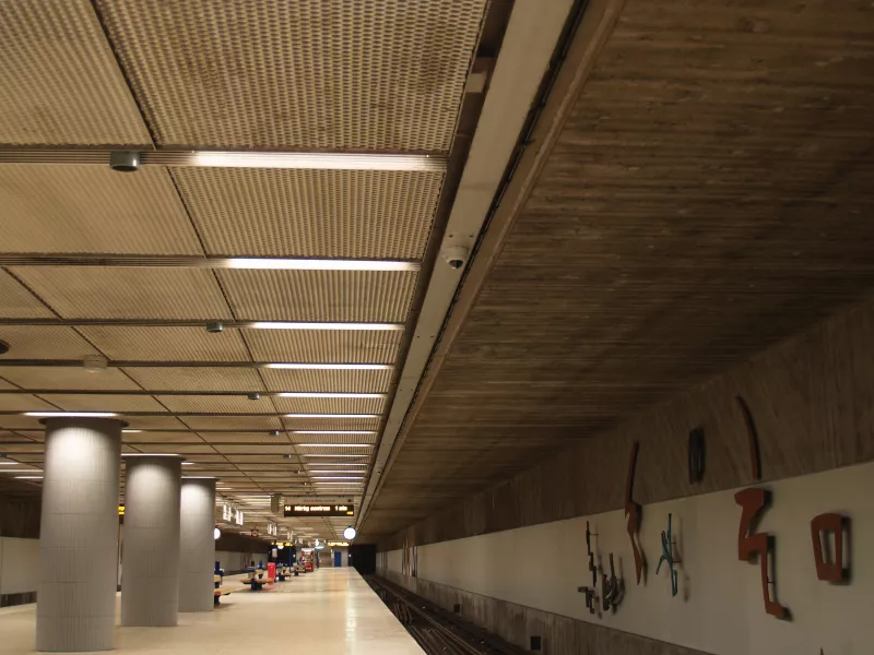 Empty subway station platform with security cameras.