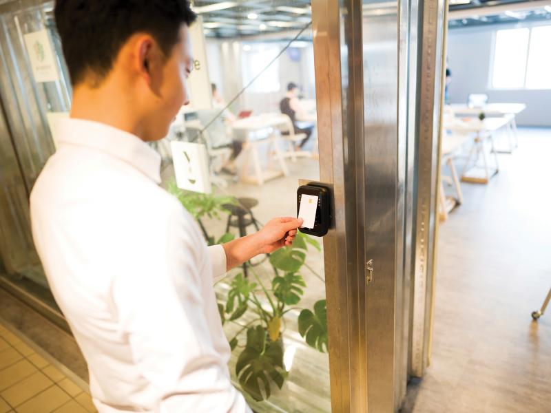 man entering a door with access card