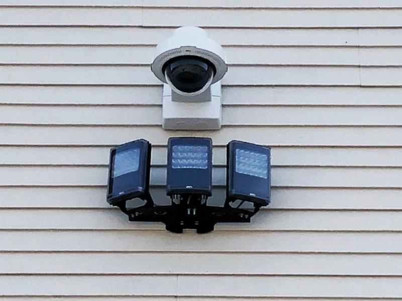Camera and illuminators on outdoor wall