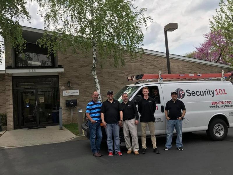 Integrator team standing by van in front of Arc of Monmouth