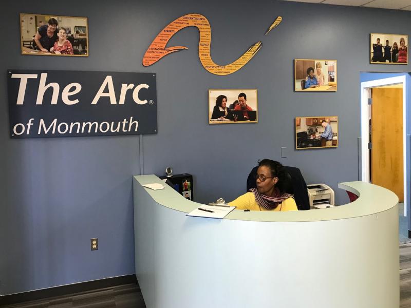 Woman at front desk of Arc of Monmouth