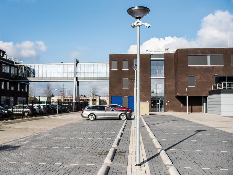 Parking lot with pole cameras in front of BIT building
