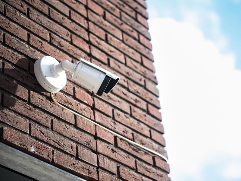 Camera on brick wall