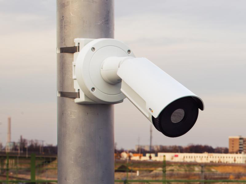 Camera on pole with recycling site in far background