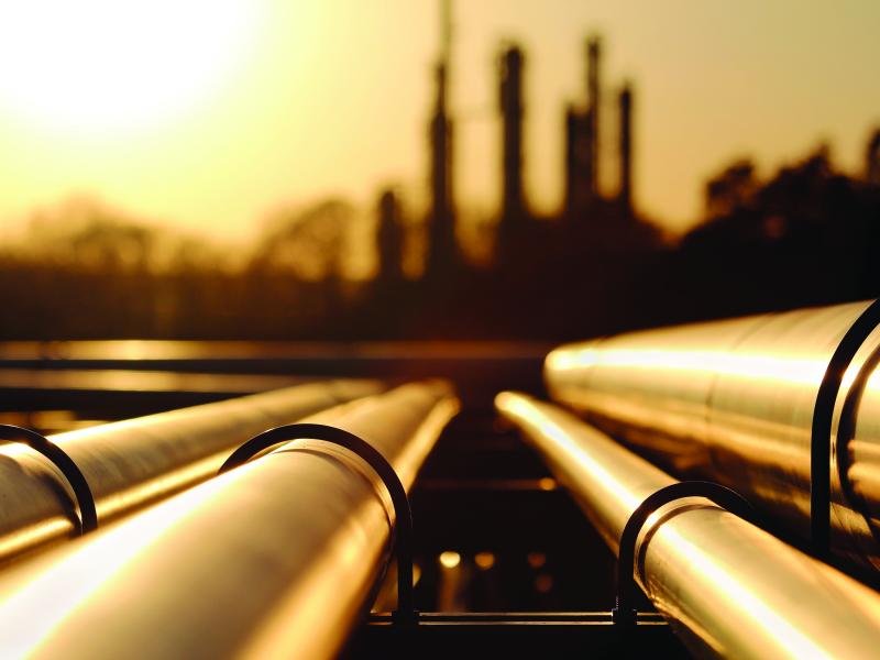 oil refinery pipes in yellow light