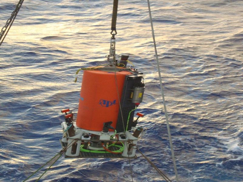 Underwater equipment being lowered into water from boat