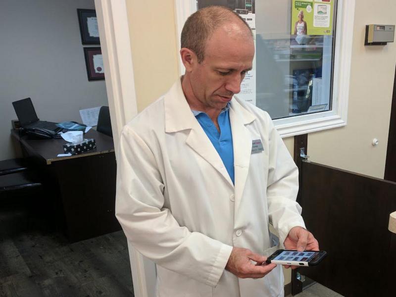 Pharmacist viewing video on smartphone