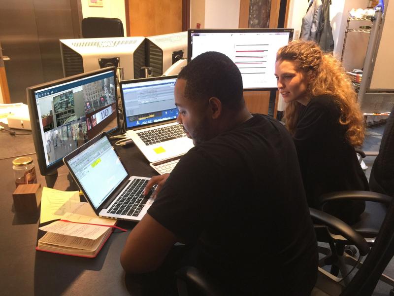 Two people in control room remote troubleshooting
