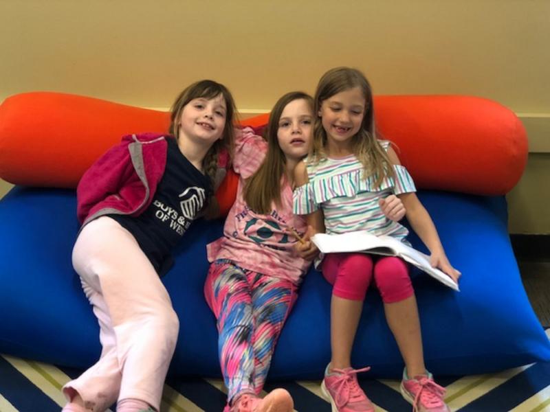 3 girls on bean bag reading books