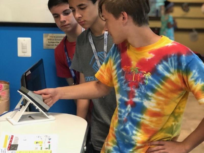3 boys using fingerprint scan