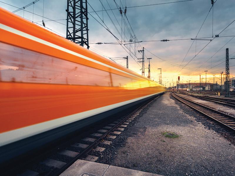 Train on railroad during sunset