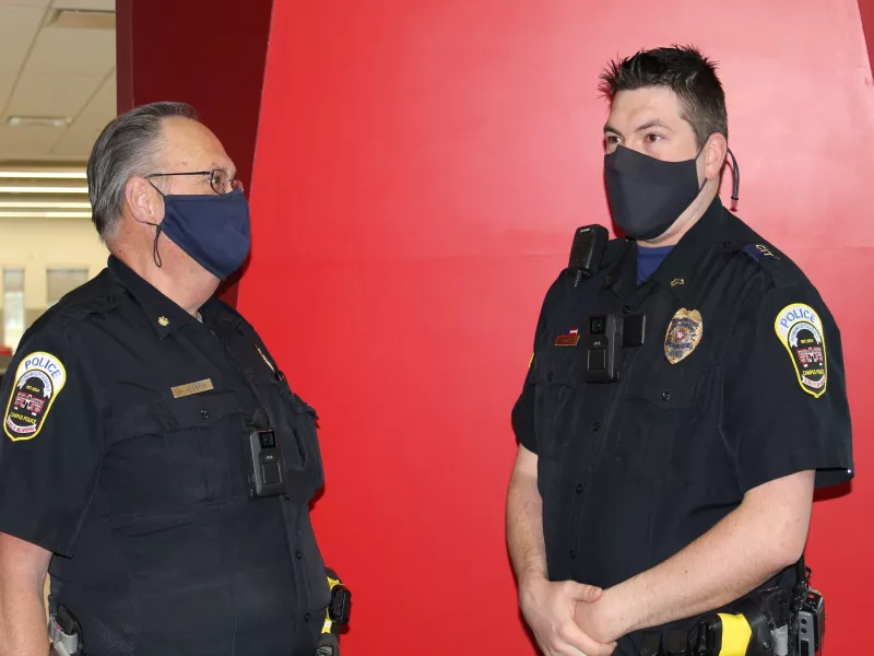Two Putnam City Campus Police officers wear body worn cameras