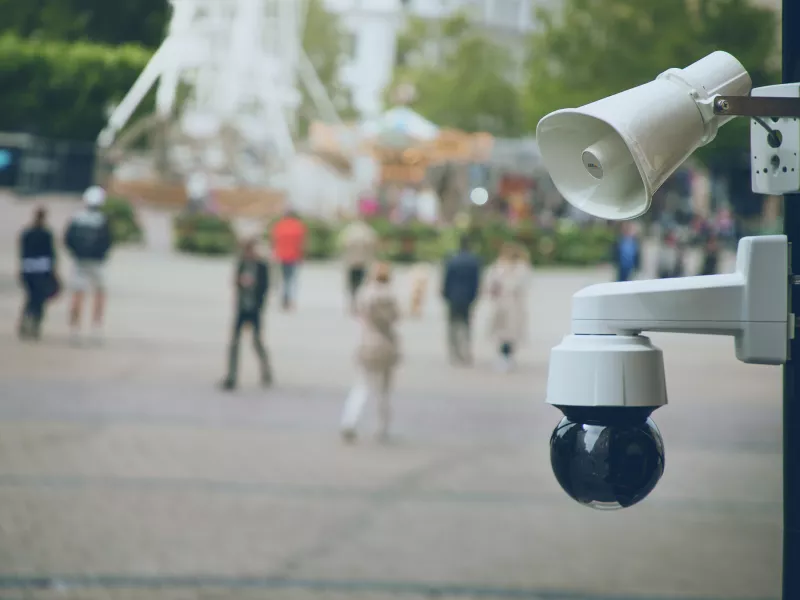 c1310e and q1655ee mounted on a pole in a city square