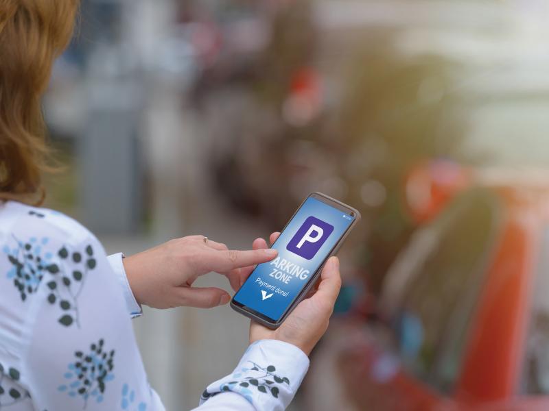 Woman with parking app- on smartphone