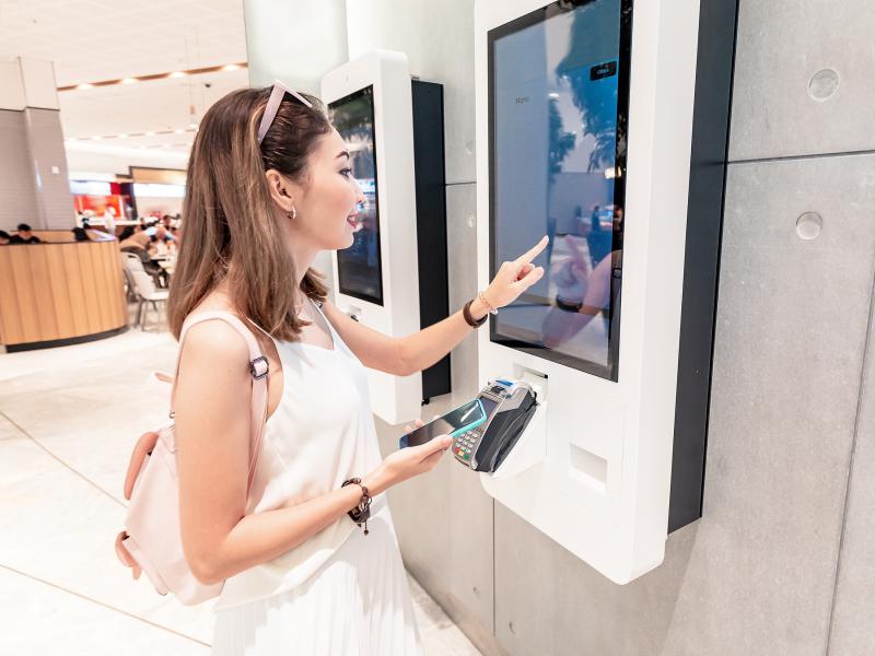 woman ordering selfservice by a terminal