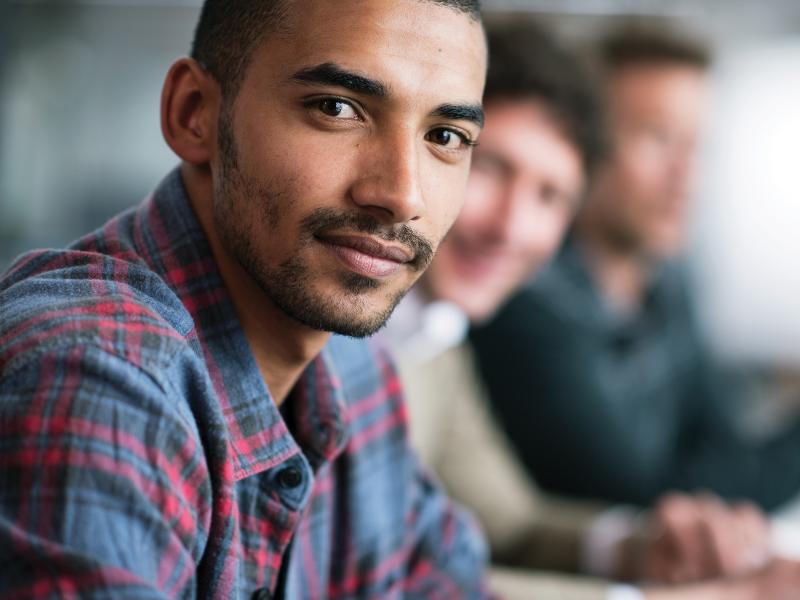 Man looking in to the camera during a meeting