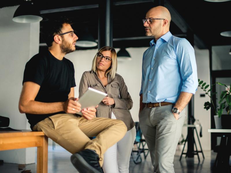 Three people having a talk at office