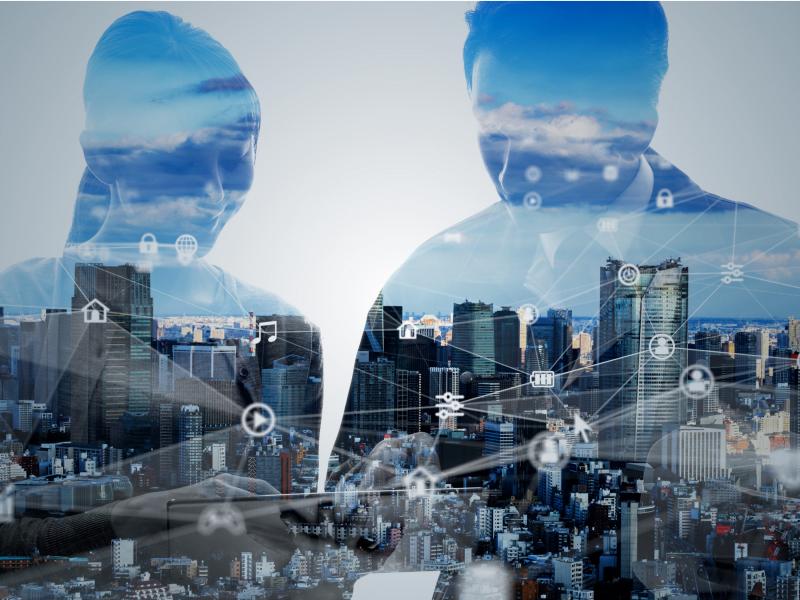 view of a big city, a man and a woman looking at a screen, network of icons  in the foreground