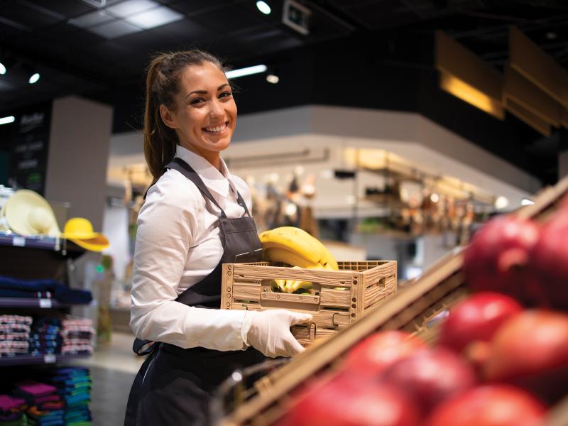 person stocking fruit