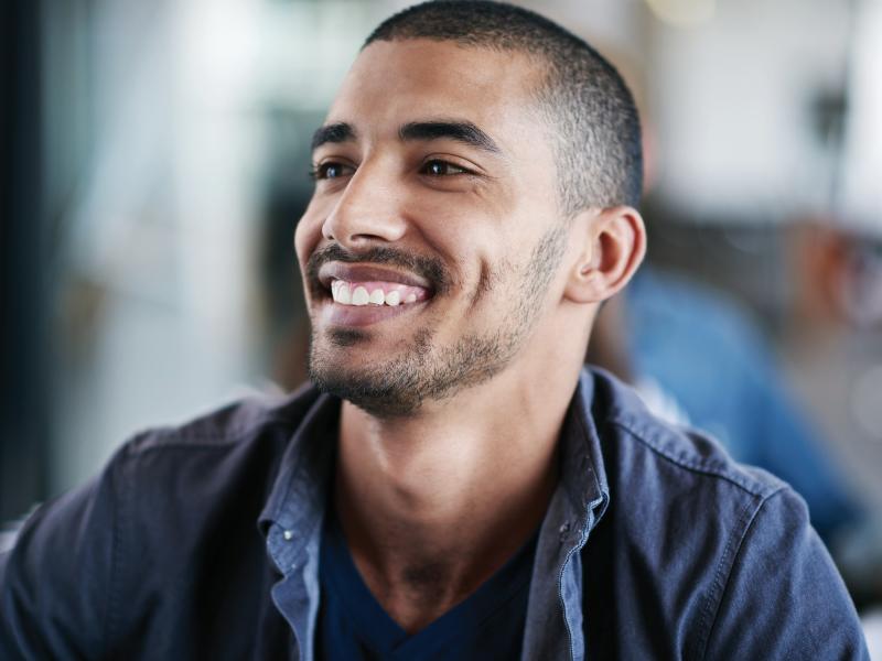 Man smiling, from the left side