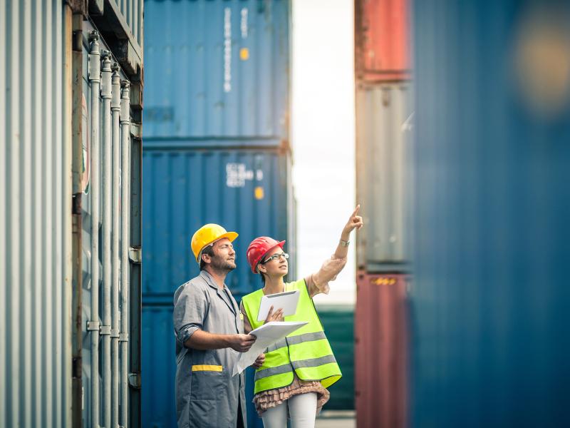 Man and woman pointing at containers