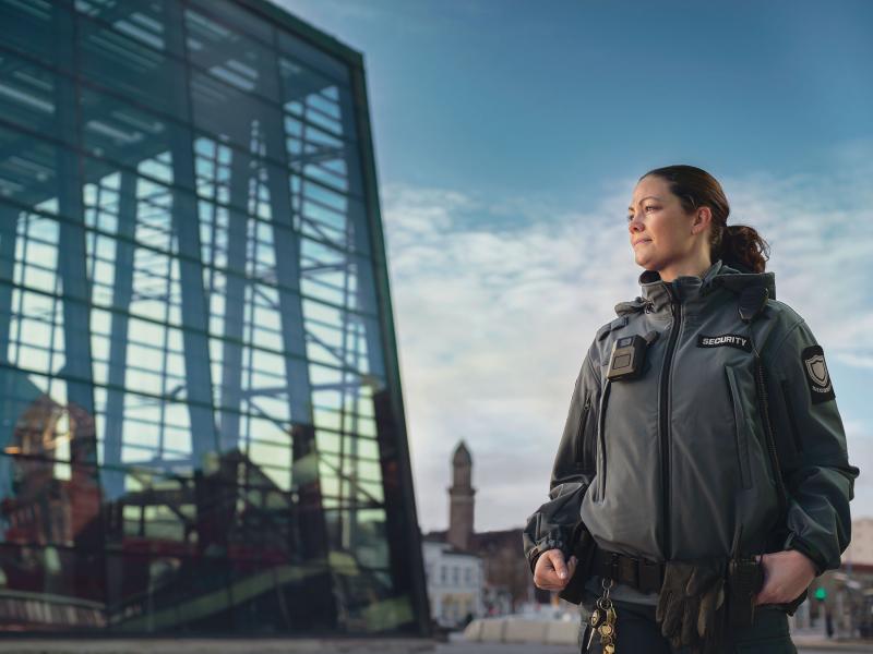 A female security guard wearing AXIS W100 Body Worn Camera