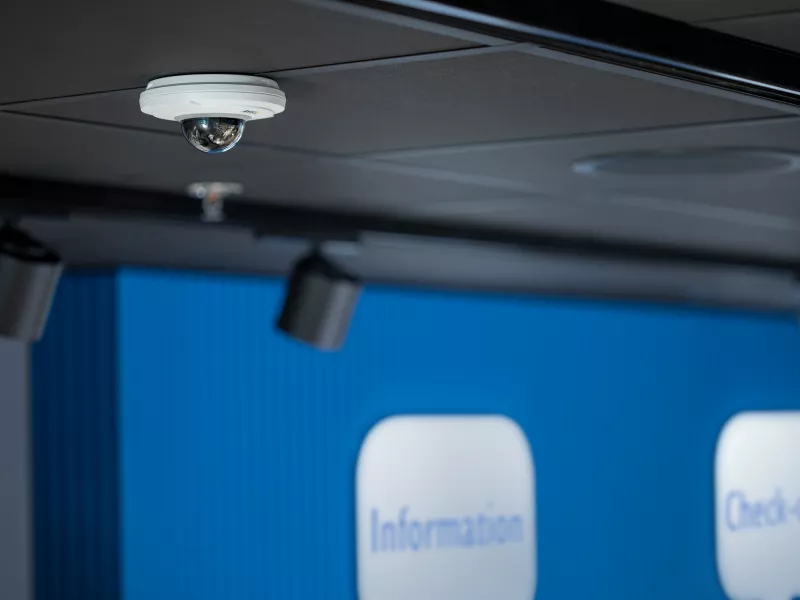 M5074 PTZ Camera hanging from a ceiling in retail store