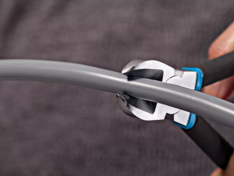 Wire cuters cuting a wire