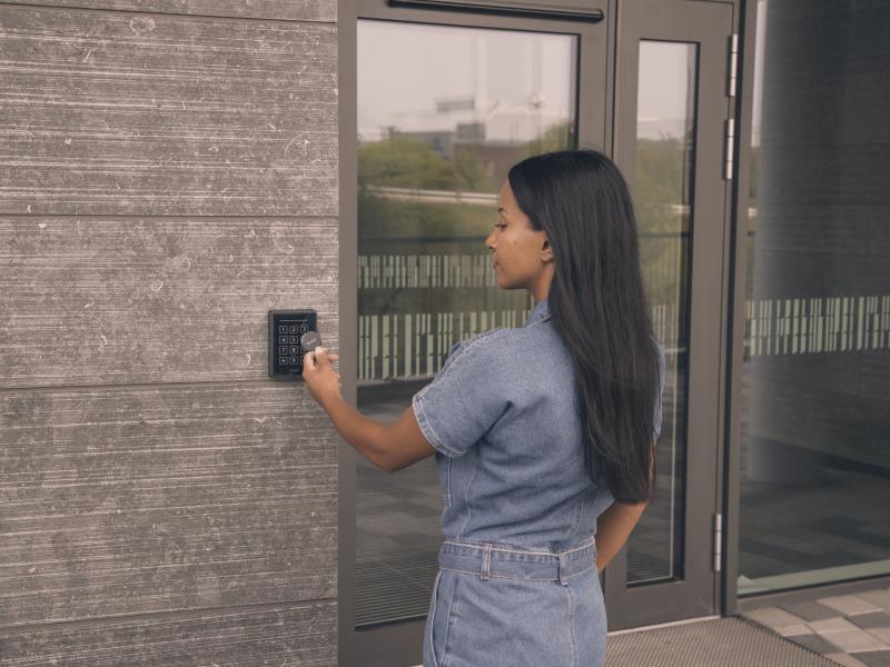 Person yousing key reader outside a door