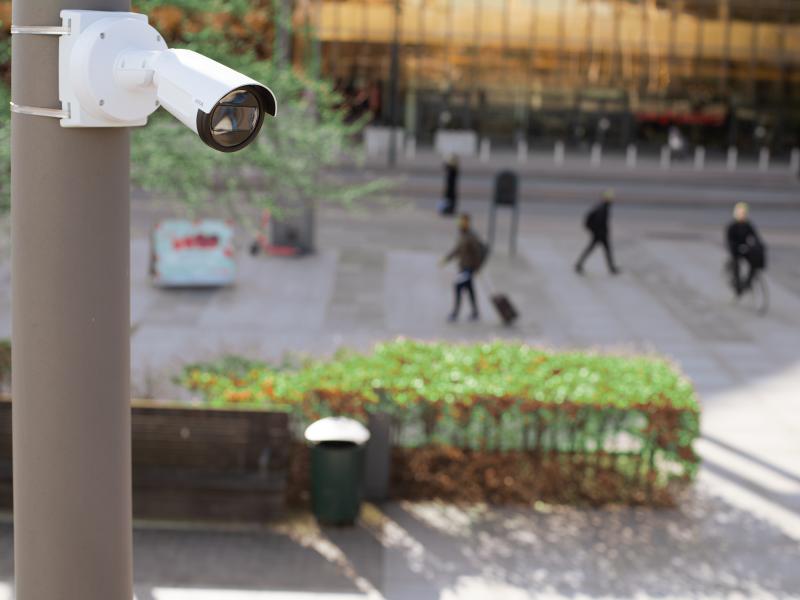 P1468 mounted on a pole in a city square. People are walking in the background.