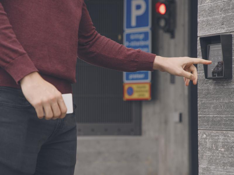 Man entering code to a garage.