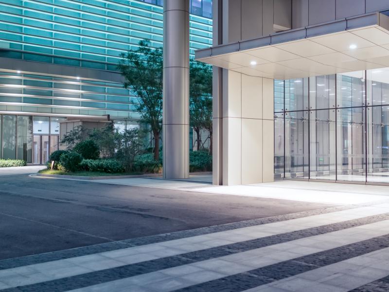 Exterior entrance of a building in white during night