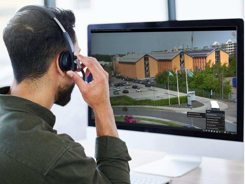 Business man working at a call center, talking to a client about Axis Optimizer.