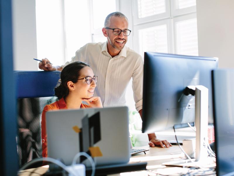 Woman and man looking at computer screen.